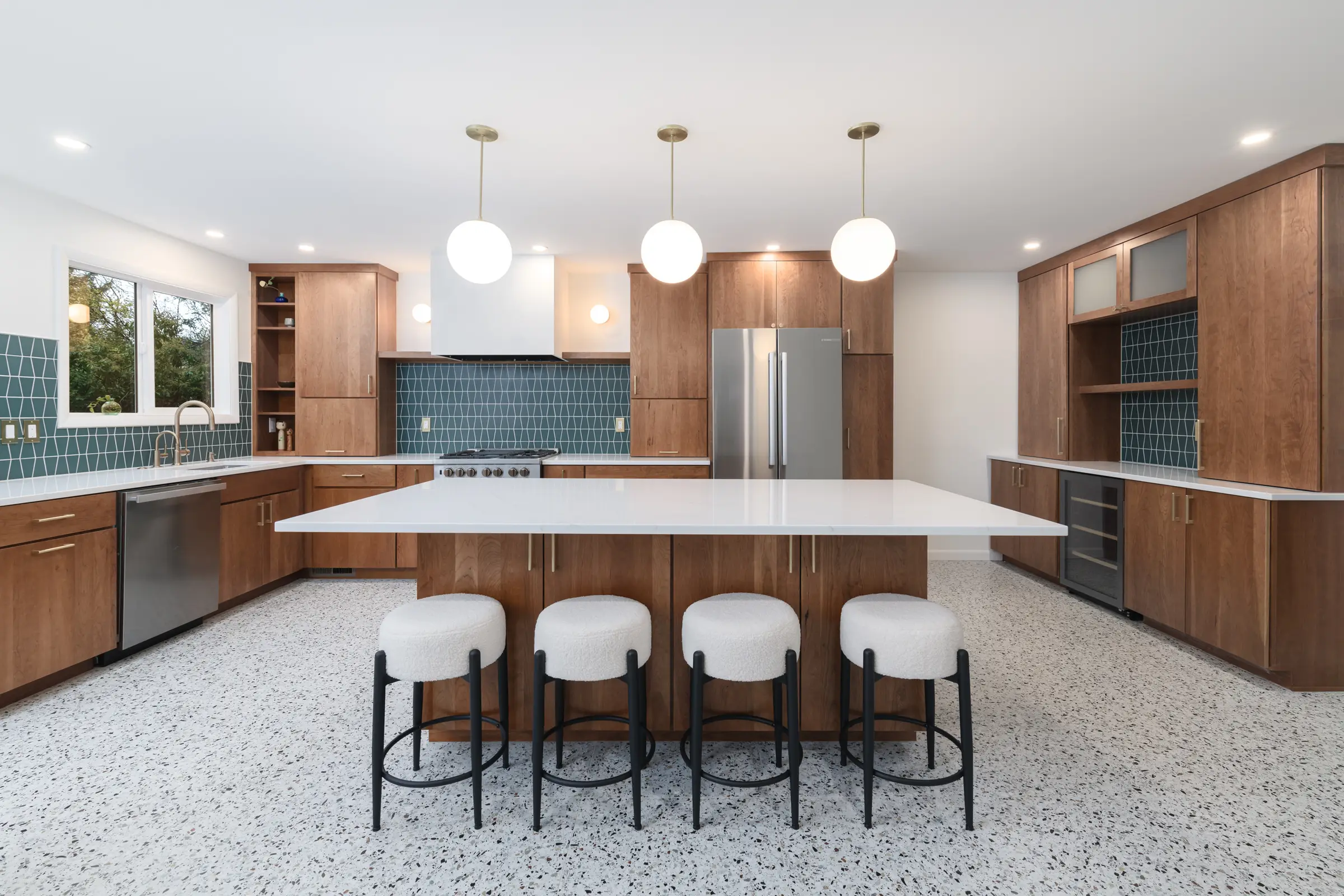Remodeled 120th Ave kitchen with walnut cabinets, teal tile backsplash, and terrazzo-style floor