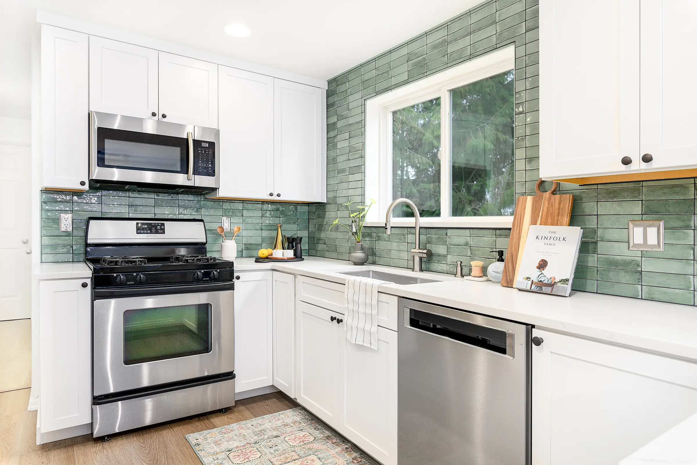 White SE Portland kitchen with a green tile backsplash and stainless appliances